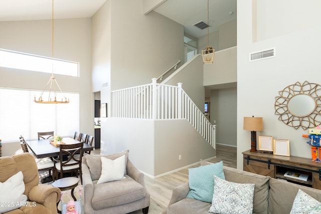 2224 W Olive Way, Chandler, AZ 85248 - living room with high vaulted ceiling, a chandelier, stairs, and wood finished floors