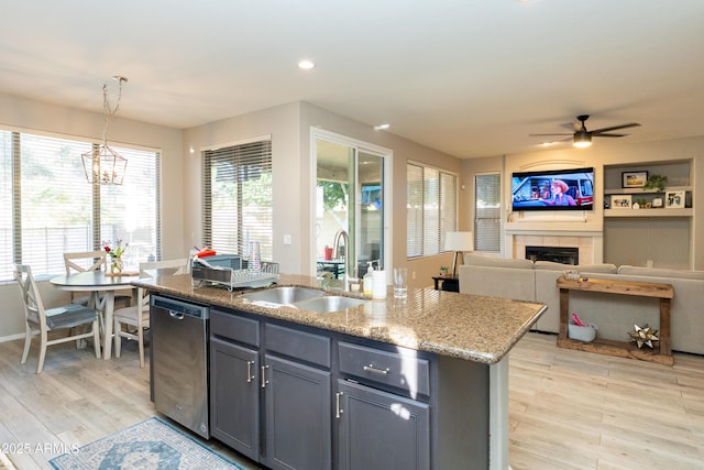 2224 W Olive Way, Chandler, AZ 85248 - kitchen featuring stainless steel dishwasher, a sink, a tiled fireplace, gray cabinetry, and light wood-style floors