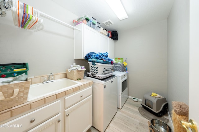 2224 W Olive Way, Chandler, AZ 85248 - laundry room featuring independent washer and dryer, cabinet space, light wood finished floors, and baseboards