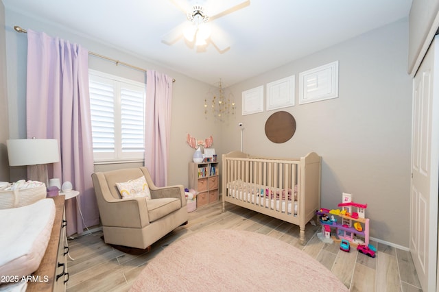 2224 W Olive Way, Chandler, AZ 85248 - bedroom featuring wood finished floors, a crib, and baseboards