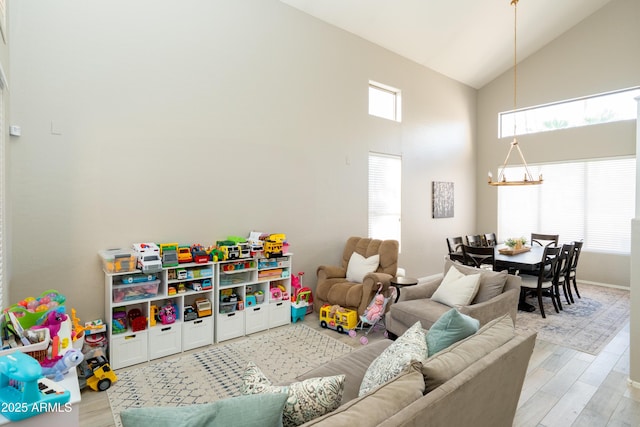 2224 W Olive Way, Chandler, AZ 85248 - recreation room featuring a chandelier, high vaulted ceiling, light wood-style floors, and baseboards