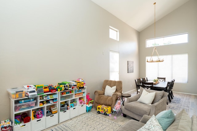 2224 W Olive Way, Chandler, AZ 85248 - rec room featuring a chandelier, high vaulted ceiling, baseboards, and light wood-type flooring