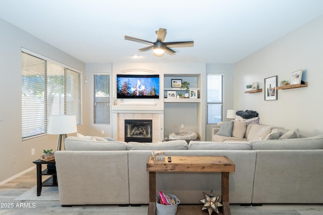 2224 W Olive Way, Chandler, AZ 85248 - living area featuring a ceiling fan, light wood-style floors, a tile fireplace, and baseboards