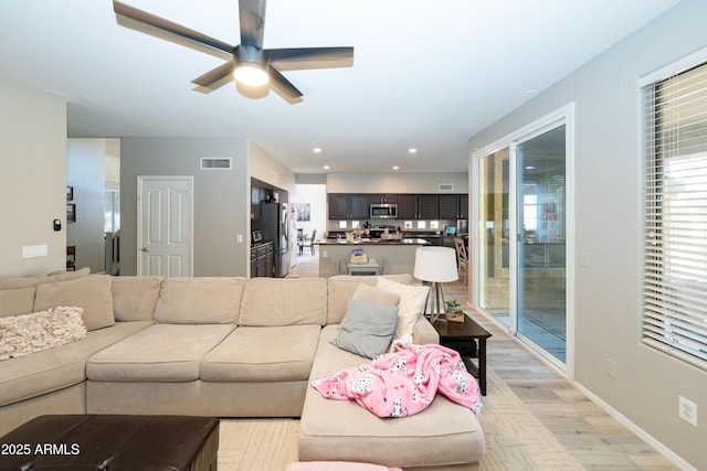 2224 W Olive Way, Chandler, AZ 85248 - living area featuring ceiling fan, baseboards, and light wood-style floors