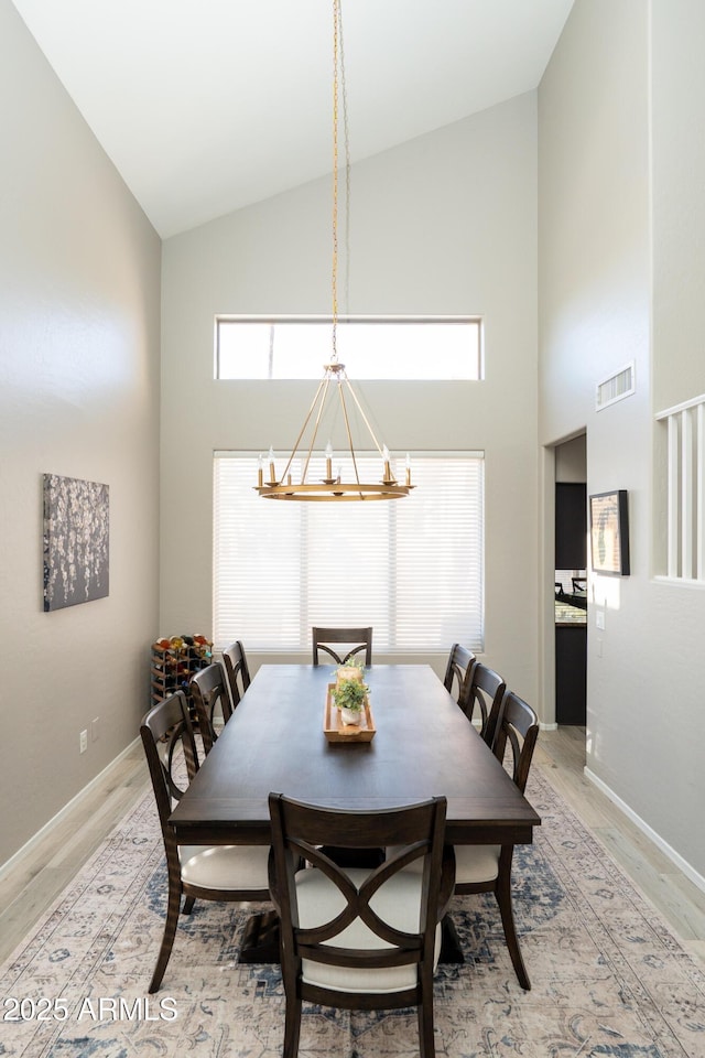 2224 W Olive Way, Chandler, AZ 85248 - dining room with high vaulted ceiling, light wood-style floors, a chandelier, and baseboards