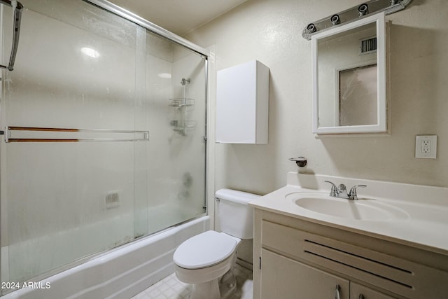 full bathroom featuring combined bath / shower with glass door, vanity, and toilet