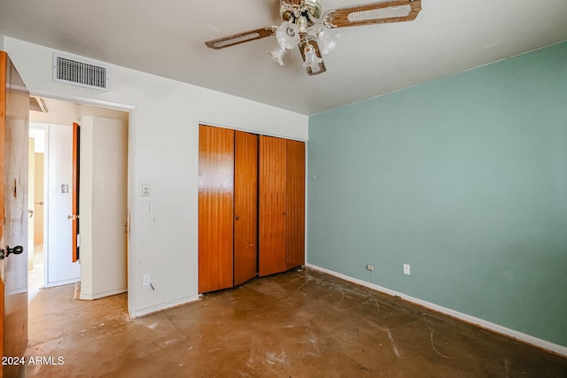 unfurnished bedroom with ceiling fan, concrete floors, and a closet