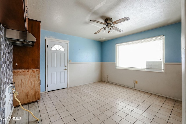 interior space featuring ceiling fan and a textured ceiling