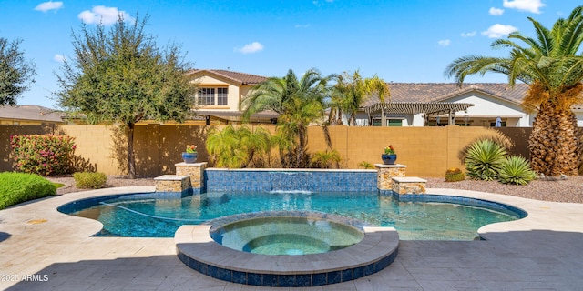 view of pool with a fenced backyard and a pool with connected hot tub