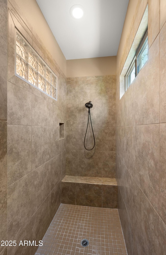 bathroom featuring a tile shower