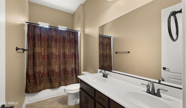 bathroom featuring tile patterned flooring, double vanity, toilet, and a sink