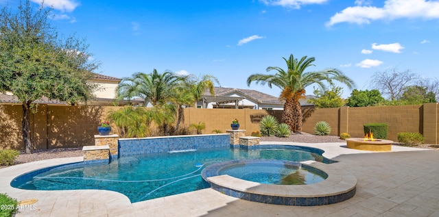 view of swimming pool with a patio area, an outdoor fire pit, a fenced backyard, and a pool with connected hot tub