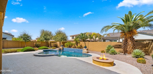 view of swimming pool with an in ground hot tub, a patio, an outdoor fire pit, and a fenced backyard