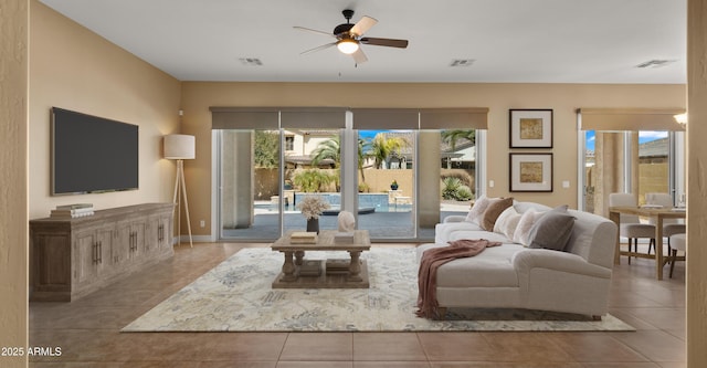 tiled living area with visible vents, plenty of natural light, and ceiling fan