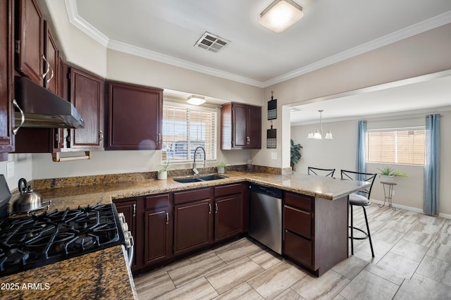 405 W Monte Way, Phoenix, AZ 85041 - kitchen with stainless steel appliances, a sink, under cabinet range hood, a breakfast bar, and a peninsula