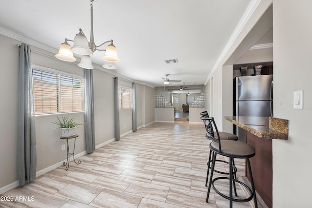 405 W Monte Way, Phoenix, AZ 85041 - kitchen featuring crown molding, freestanding refrigerator, baseboards, ceiling fan, and dark countertops