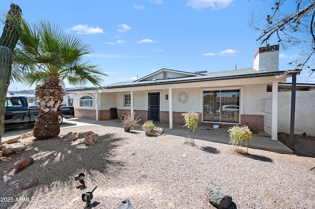 405 W Monte Way, Phoenix, AZ 85041 - ranch-style home featuring brick siding, a chimney, and covered porch