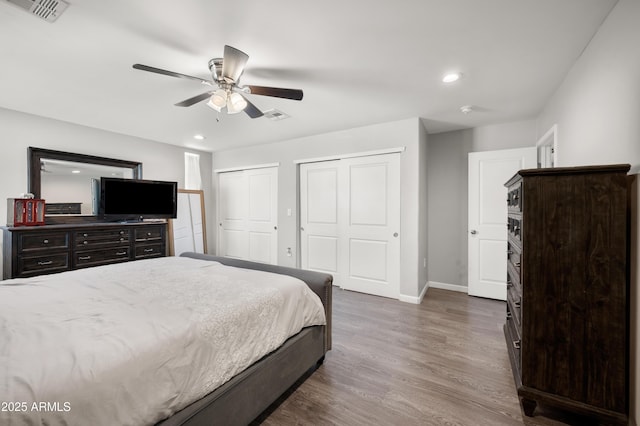 405 W Monte Way, Phoenix, AZ 85041 - bedroom with multiple closets, baseboards, wood finished floors, recessed lighting, and a ceiling fan