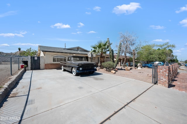 405 W Monte Way, Phoenix, AZ 85041 - view of front of property with concrete driveway, brick siding, and a gate