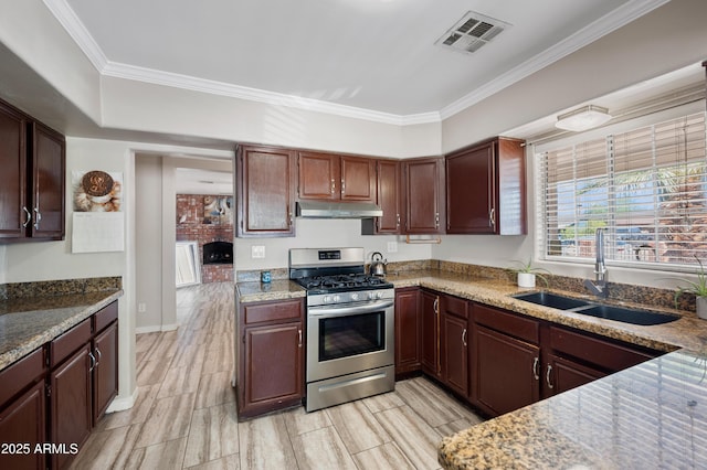 405 W Monte Way, Phoenix, AZ 85041 - kitchen with stainless steel gas range, under cabinet range hood, a sink, crown molding, and light stone countertops