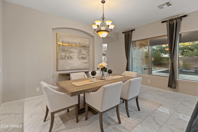 dining area featuring a notable chandelier