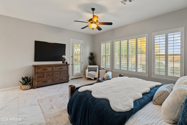 bedroom with ceiling fan, access to outside, and multiple windows