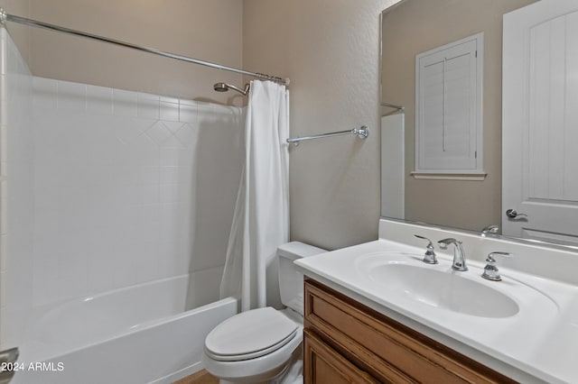 full bathroom featuring shower / tub combo, vanity, and toilet