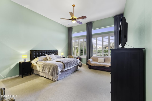 carpeted bedroom featuring baseboards and a ceiling fan