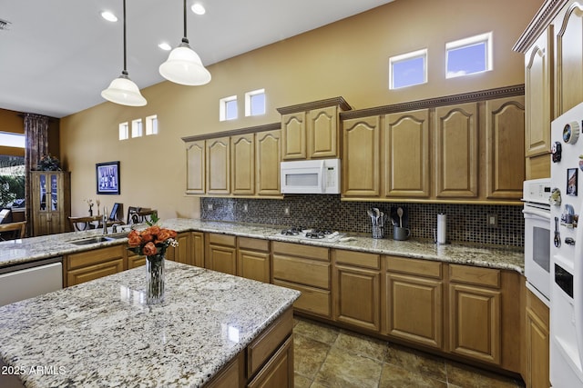 kitchen featuring decorative backsplash, white appliances, and a healthy amount of sunlight