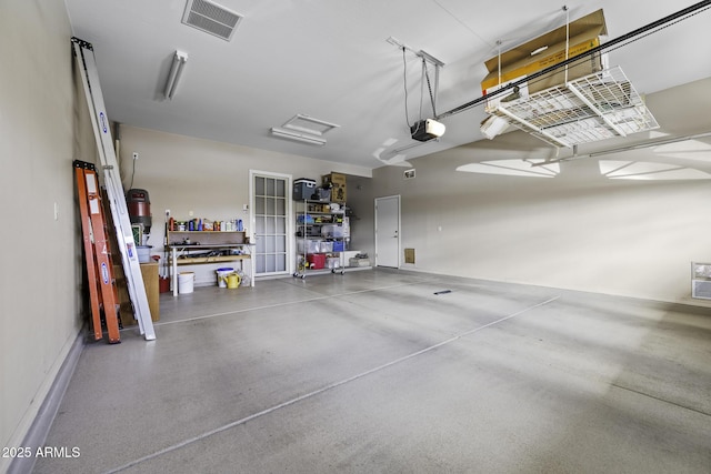 garage featuring visible vents and a garage door opener