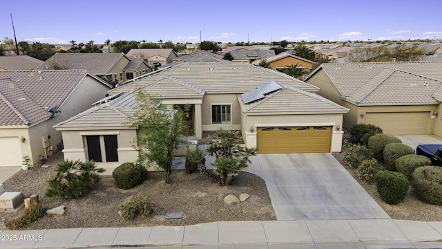 view of front of home featuring driveway, stucco siding, an attached garage, and a tile roof