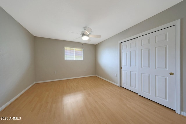 unfurnished bedroom with light wood-style floors, baseboards, and a closet