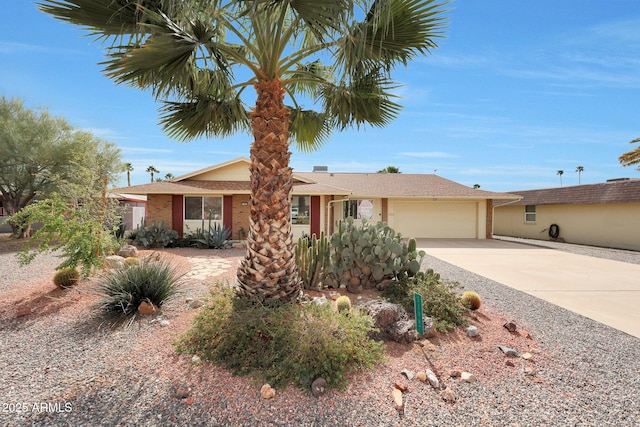 ranch-style home featuring concrete driveway and an attached garage