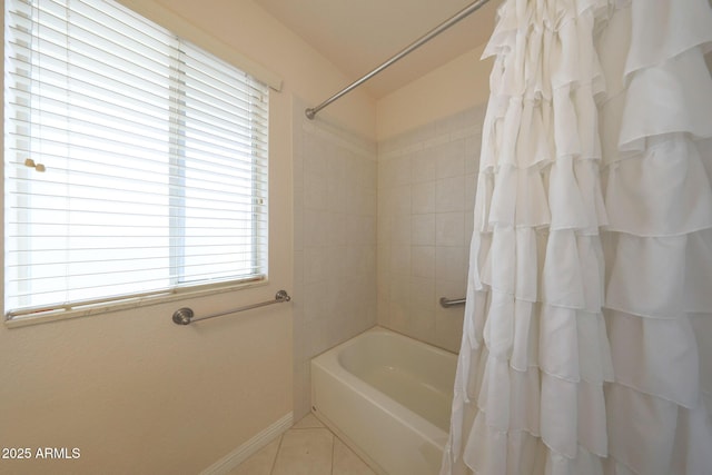 bathroom with shower / bath combination with curtain, tile patterned flooring, and baseboards