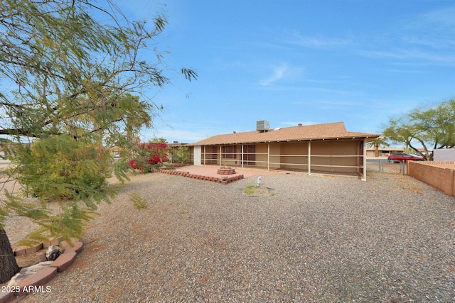 back of house featuring a sunroom, a patio area, and fence