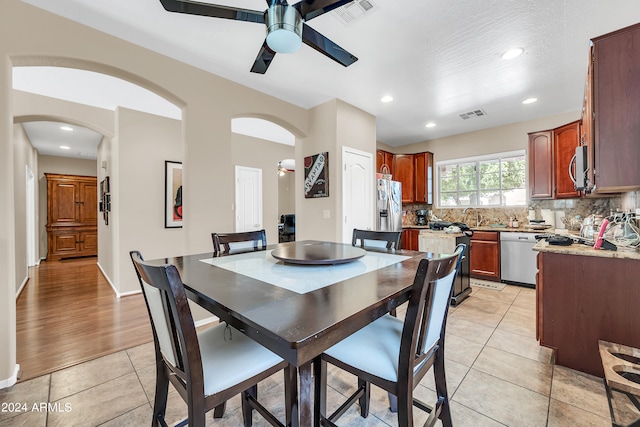 tiled dining room featuring ceiling fan