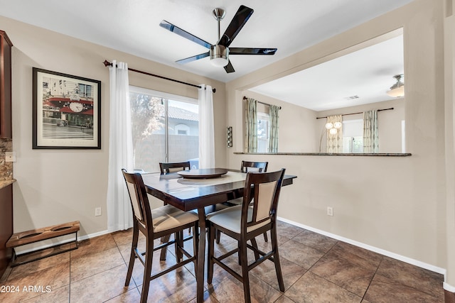 tiled dining space featuring ceiling fan