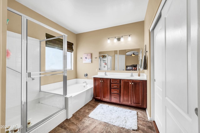 bathroom with independent shower and bath, tile floors, and double sink vanity