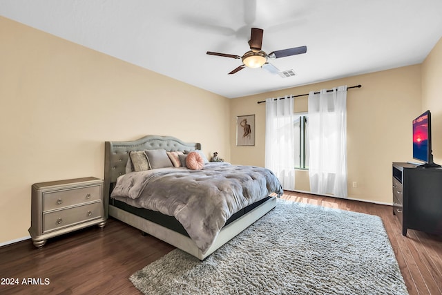 bedroom with dark wood-type flooring and ceiling fan