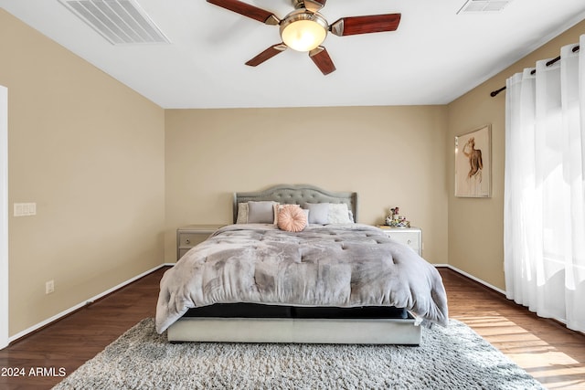 bedroom with dark hardwood / wood-style floors and ceiling fan