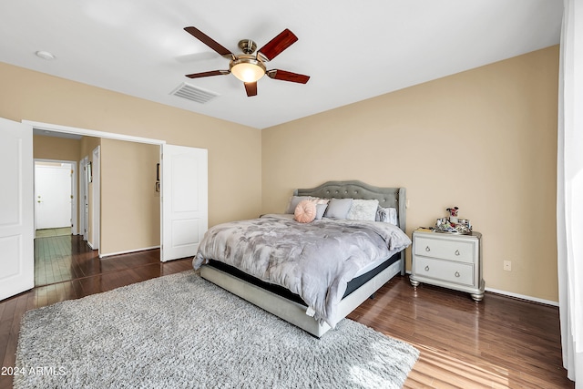 bedroom with ceiling fan and dark hardwood / wood-style flooring