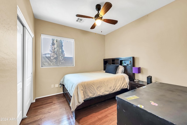 bedroom with a closet, ceiling fan, and dark hardwood / wood-style floors