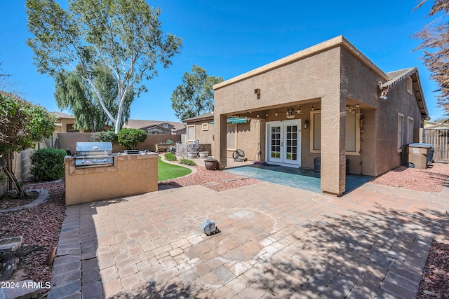 back of property featuring french doors, exterior kitchen, and a patio area