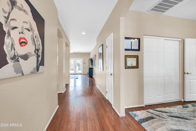 corridor with dark hardwood / wood-style flooring