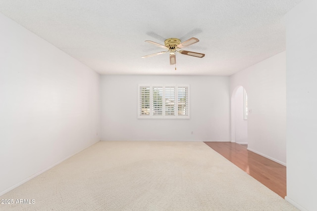 empty room featuring ceiling fan and a textured ceiling