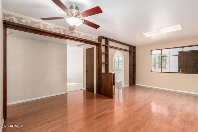 unfurnished room featuring ceiling fan and hardwood / wood-style floors