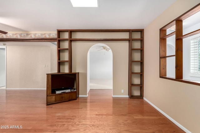 spacious closet featuring ceiling fan and light wood-type flooring