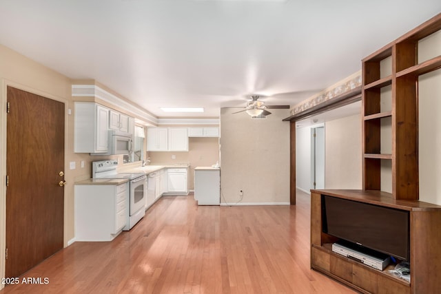 kitchen featuring white cabinetry, sink, ceiling fan, white appliances, and light hardwood / wood-style flooring