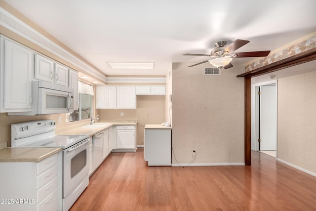 kitchen featuring sink, white cabinetry, light wood-type flooring, ceiling fan, and white appliances