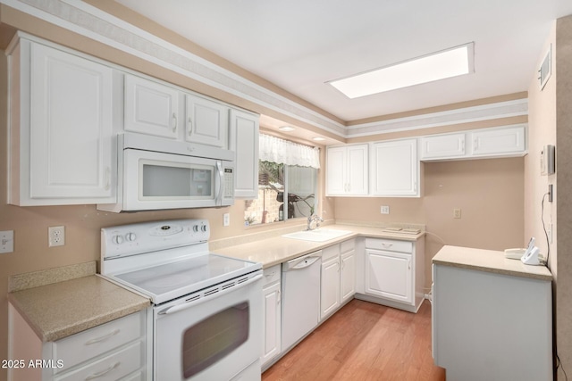 kitchen featuring sink, white cabinets, white appliances, and light wood-type flooring